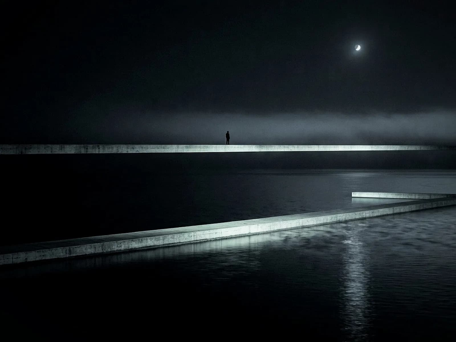 Two thin concrete ledges cross a dark sea at different heights, one figure on the upper ledge, the same moonlight caught twice on the water
