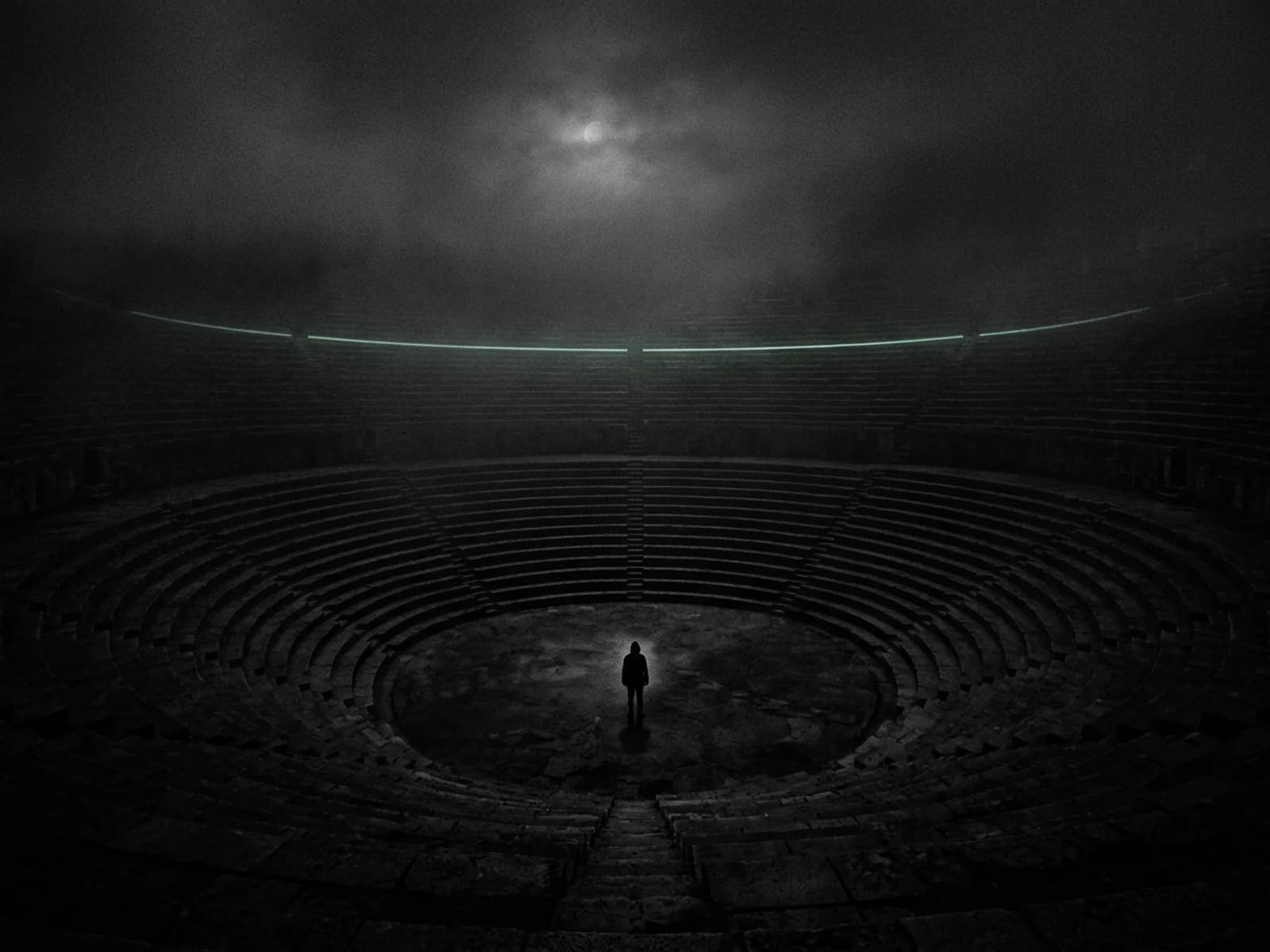 A lone figure stands at the centre of a vast dark stone amphitheatre at night, one distant ring of steps traced with pale mint light under a faint moon